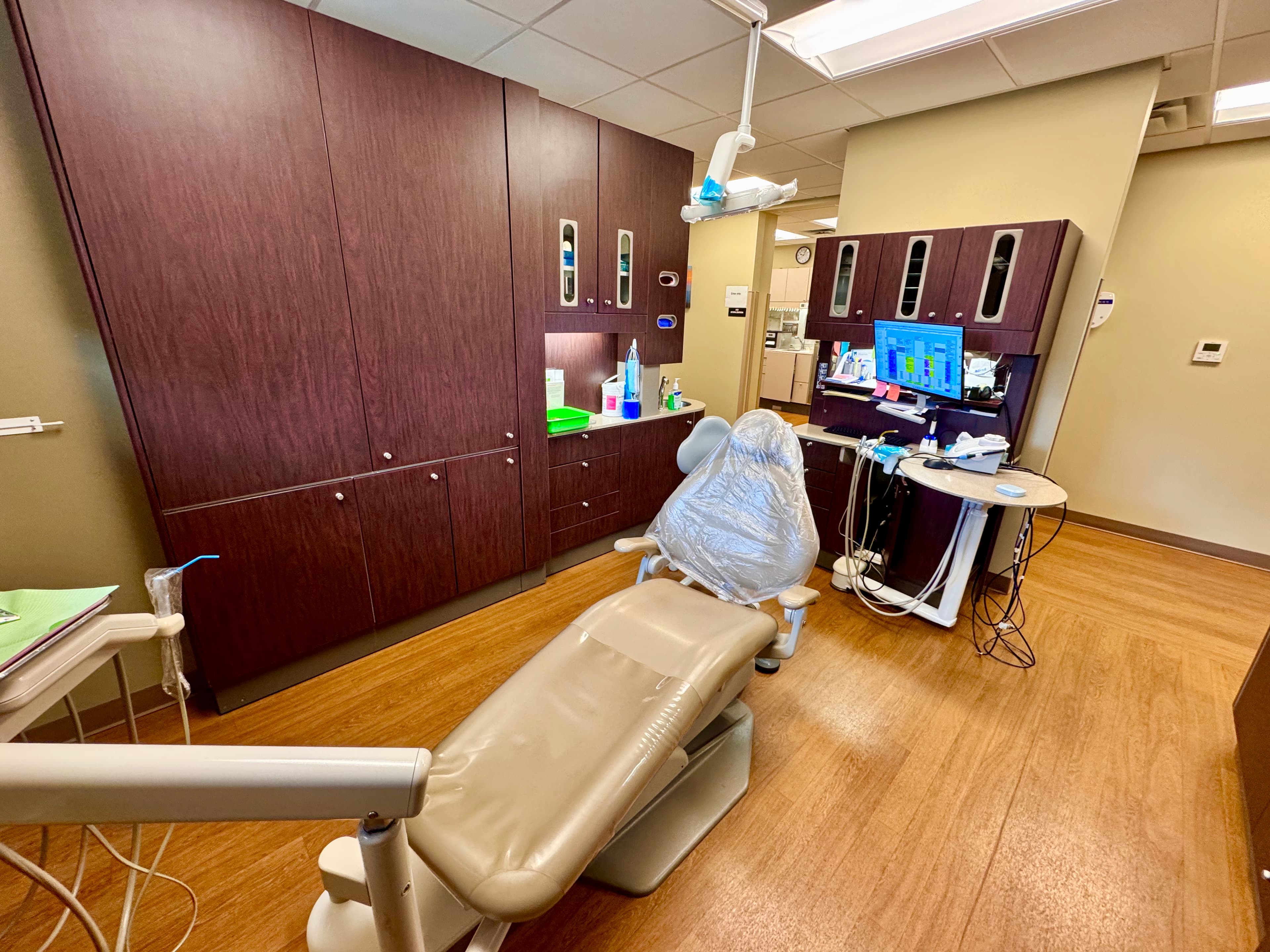 Modern dental treatment chair with overhead equipment